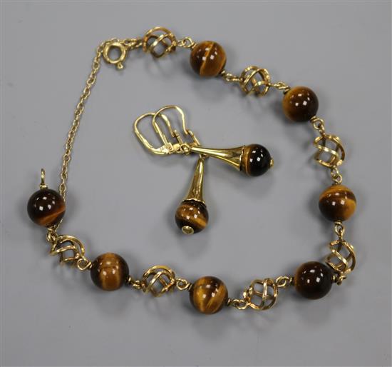 A 585 yellow metal and tigers eye quartz bead bracelet and a pair of matching earrings.